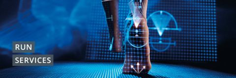 Nahaufnahme der Beine eines Läufers mit darüber gelegten digitalen Grafiken, die Datenvisualisierung und anatomische Details zeigen. Die Worte „Run Services“ stehen auf der linken Seite. Der Hintergrund ist ein futuristisches blaues digitales Gitter.