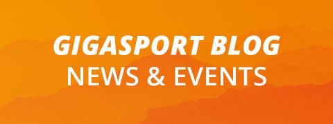 Orangefarbener Hintergrund mit Bergsilhouetten. Weißer Text lautet „GIGASPORT BLOG NEWS & EVENTS“.